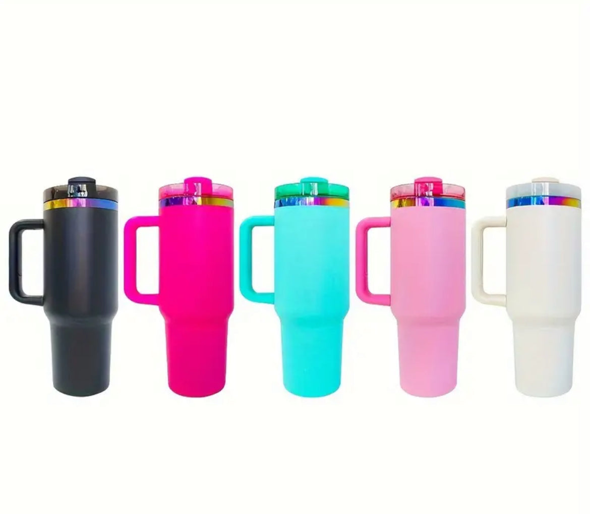 Close-up of a 40oz Rainbow Stainless Steel Tumbler with a handle, available in black pearl, white, light pink, hot pink, and teal, showcasing the sleek, insulated design perfect for hot and cold beverages.
