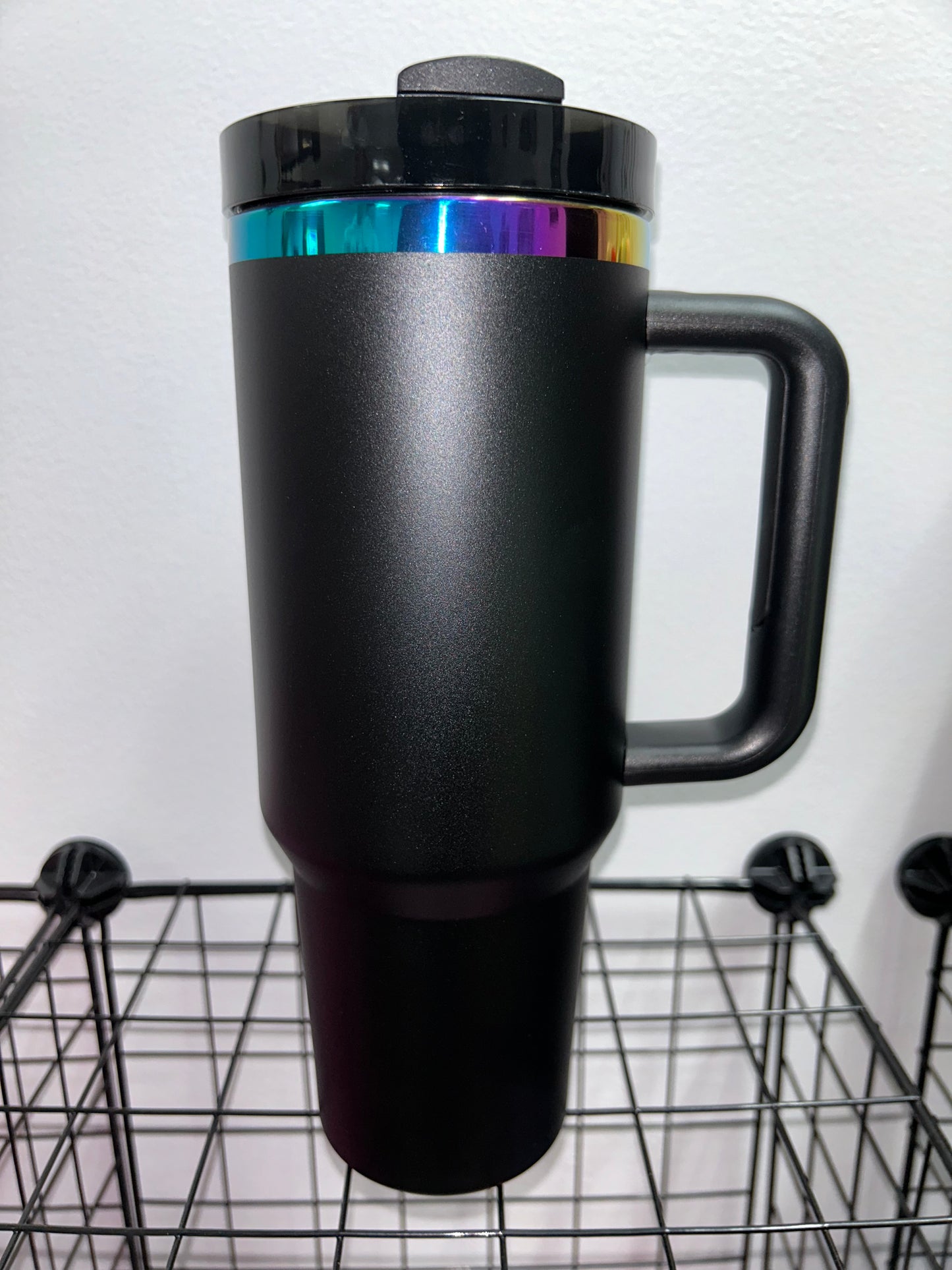 Close-up of a 40oz Rainbow Stainless Steel Tumbler with a handle, available in black pearl, white, light pink, hot pink, and teal, showcasing the sleek, insulated design perfect for hot and cold beverages.