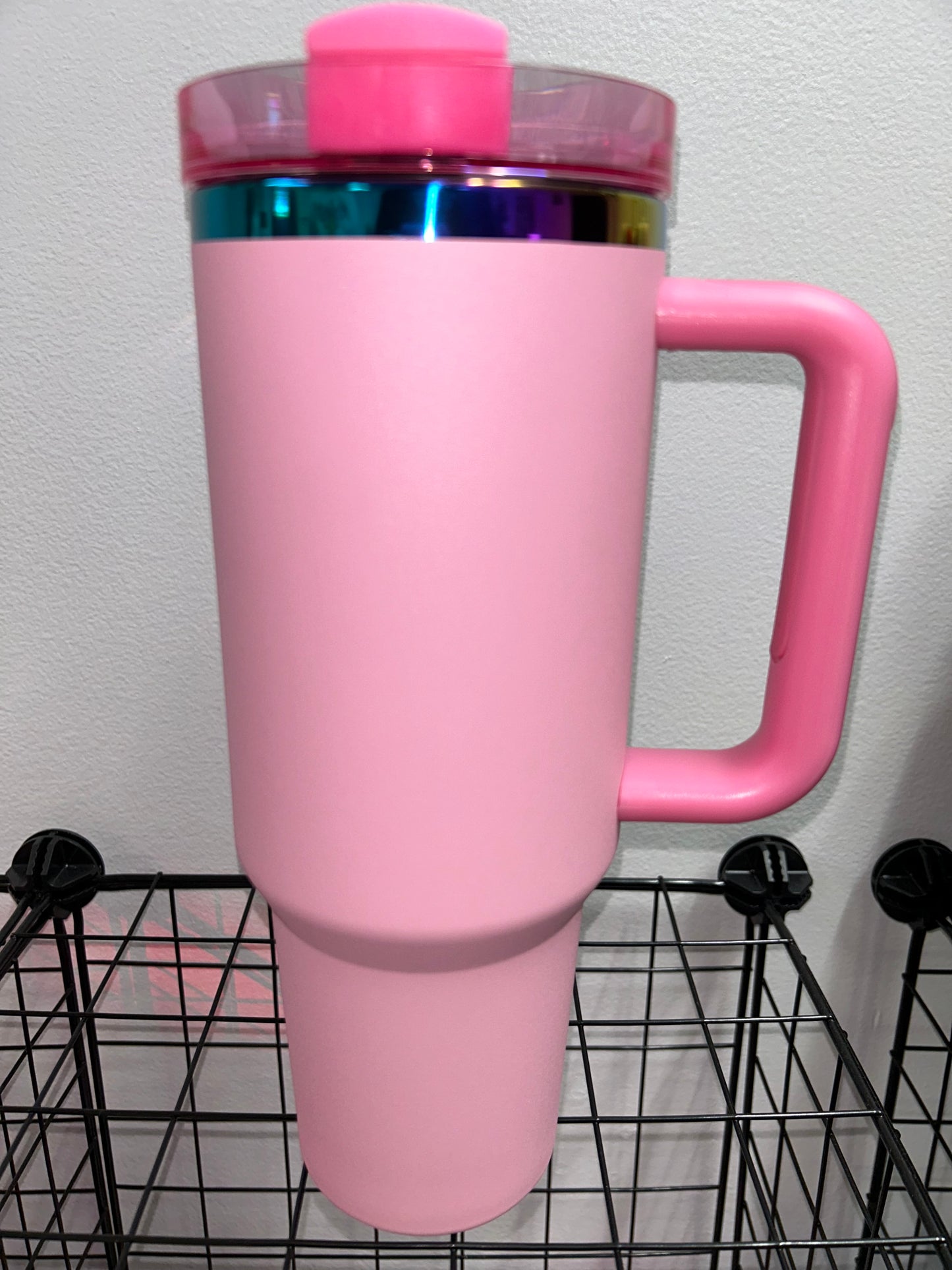Close-up of a 40oz Rainbow Stainless Steel Tumbler with a handle, available in black pearl, white, light pink, hot pink, and teal, showcasing the sleek, insulated design perfect for hot and cold beverages.