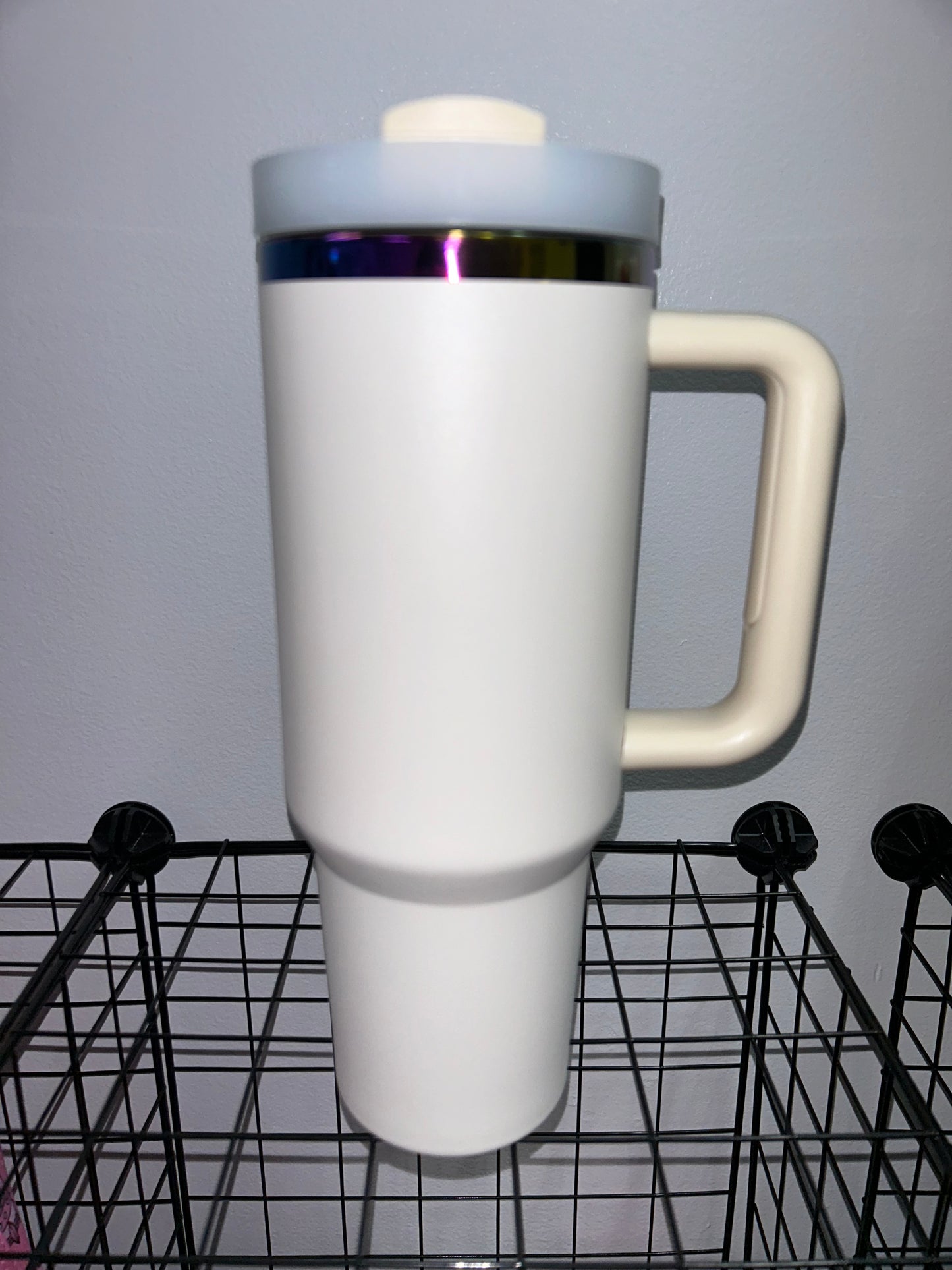 Close-up of a 40oz Rainbow Stainless Steel Tumbler with a handle, available in black pearl, white, light pink, hot pink, and teal, showcasing the sleek, insulated design perfect for hot and cold beverages.

