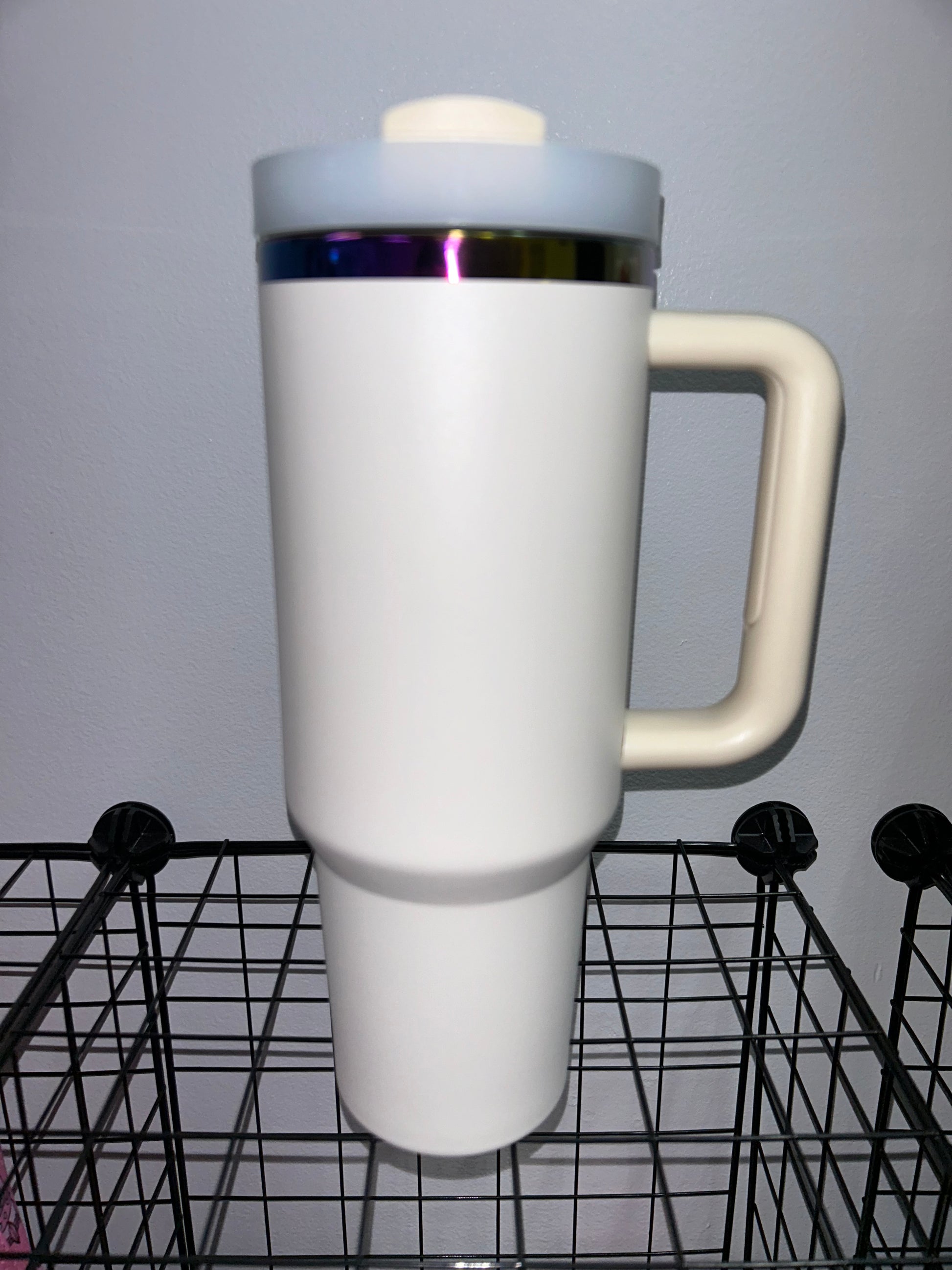 Close-up of a 40oz Rainbow Stainless Steel Tumbler with a handle, available in black pearl, white, light pink, hot pink, and teal, showcasing the sleek, insulated design perfect for hot and cold beverages.
